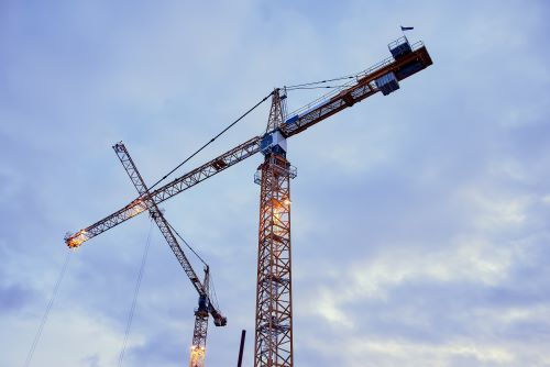Lattice crane with cloudy sky background.